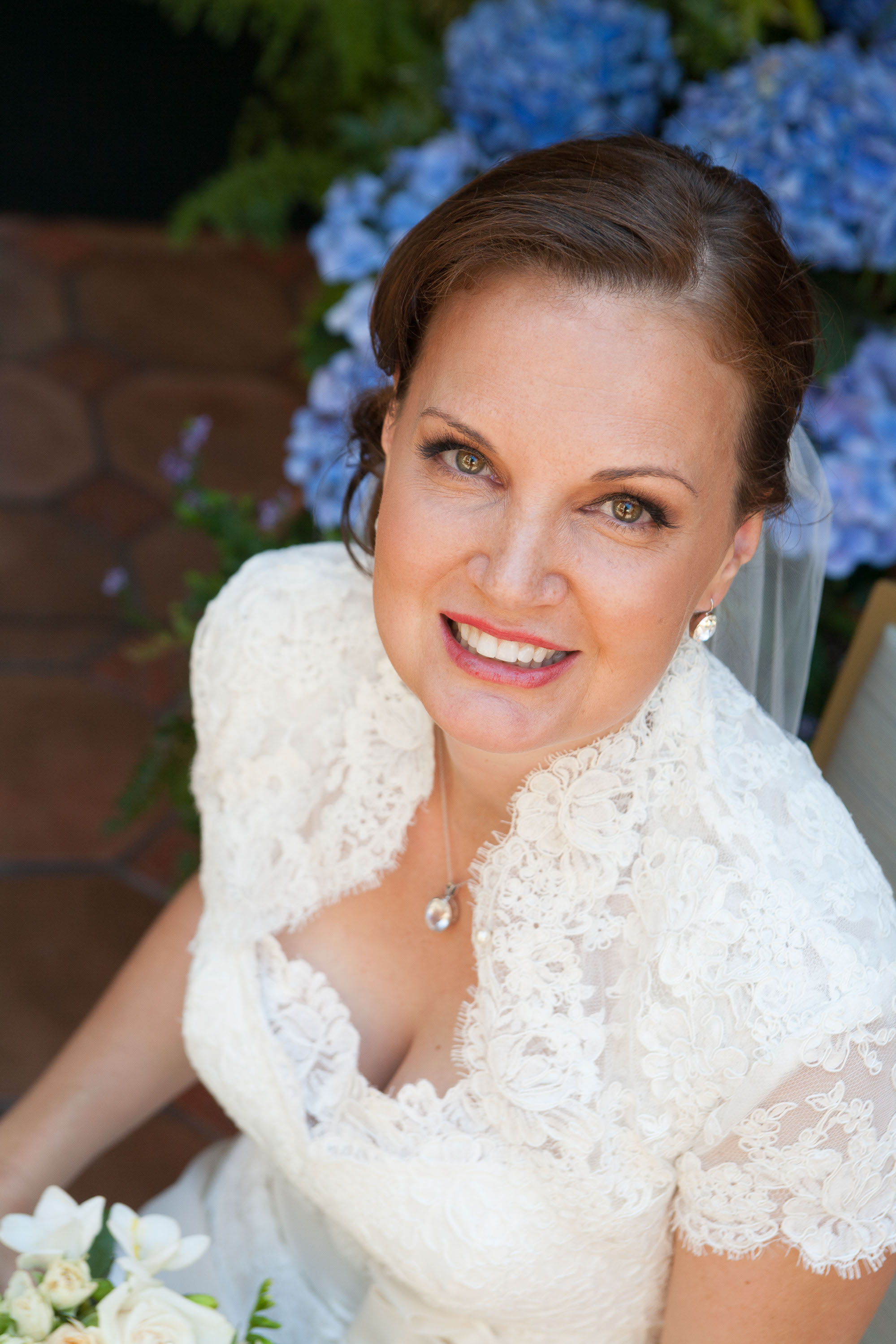 A radiant bride framed by blue Mums at the Garden Court Hotel in Palo Alto