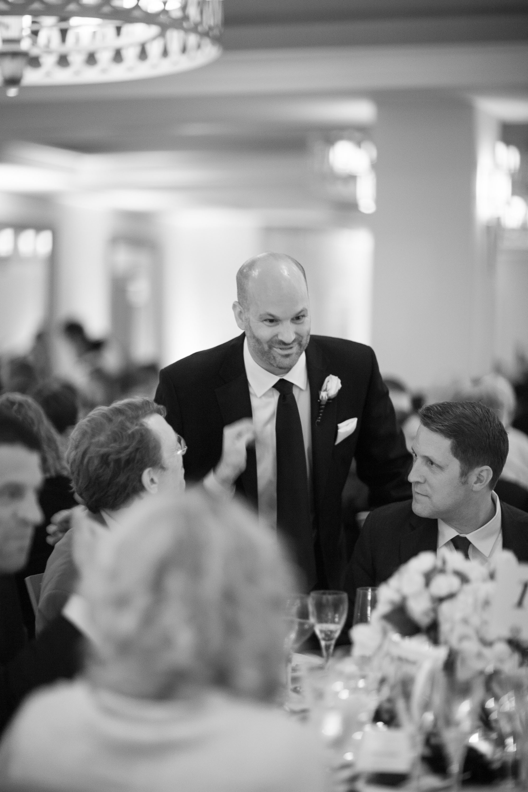 The groom speaks with his guests during dinner at the Garden Court Hotel in Palo Alto