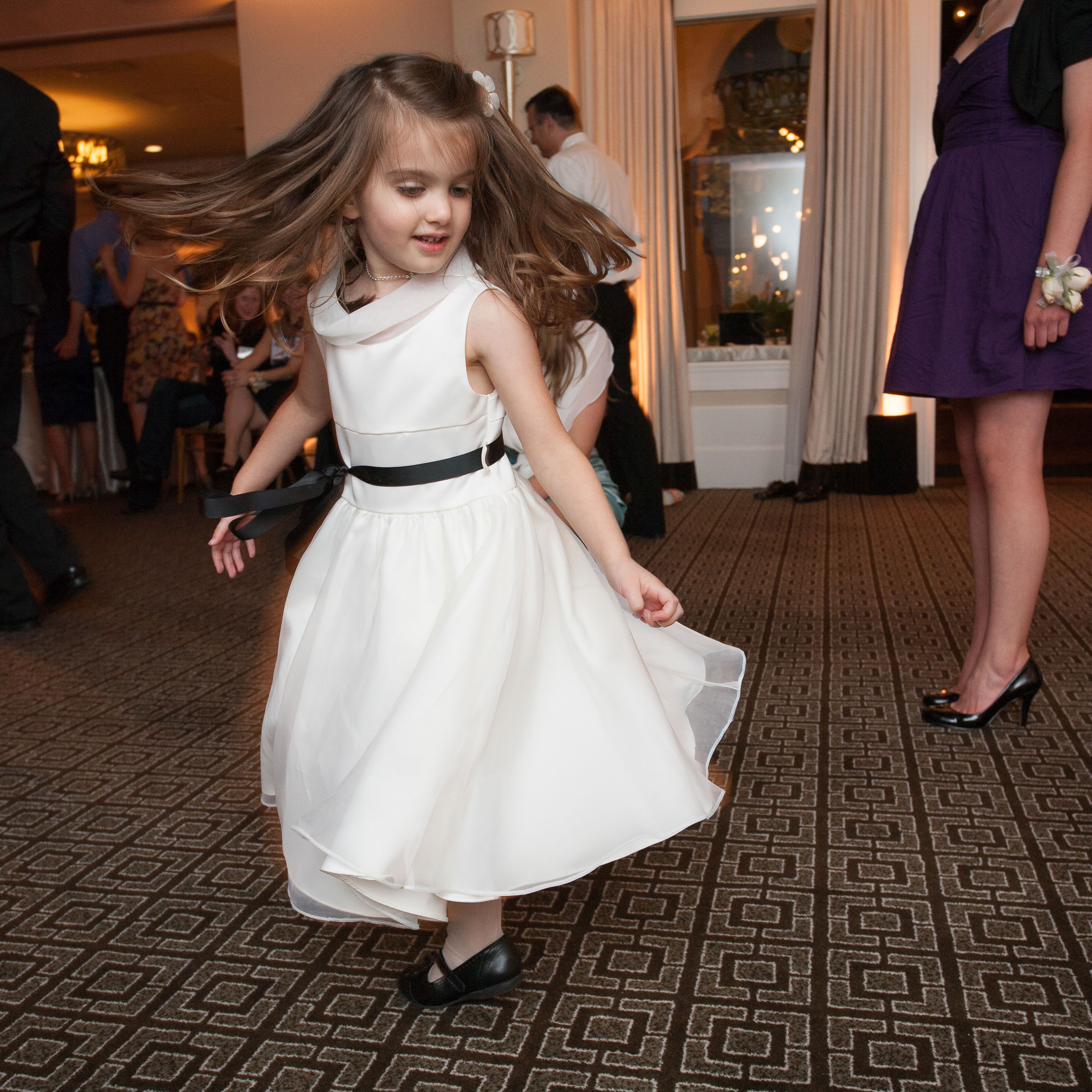 A young girl twirls at the Garden Court Hotel in Palo Alto