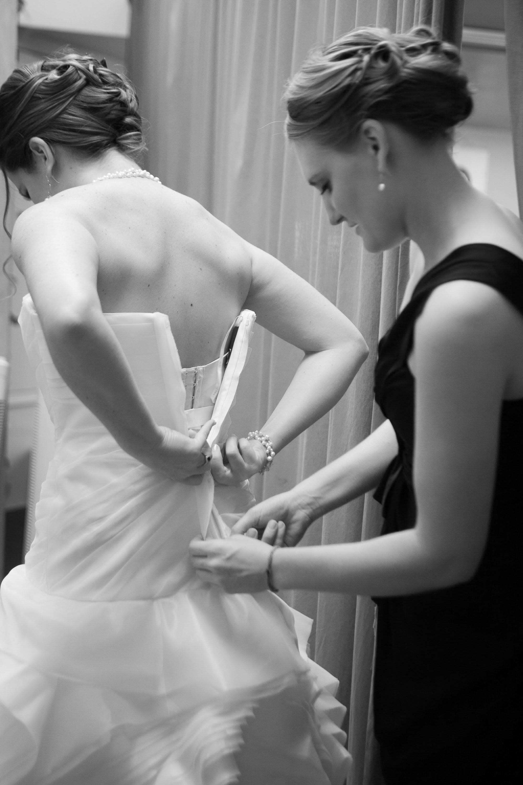 The bride zips up her Vera Wang gown at Pema Osel Ling in the Santa Cruz mountains