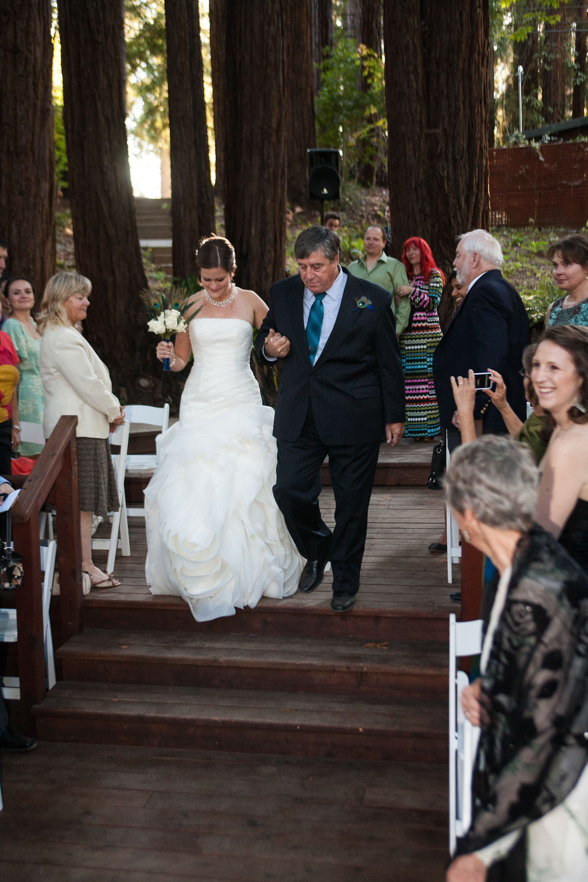 The bride and her dad walk down the aisle at Pema Osel Ling in the Santa Cruz mountains