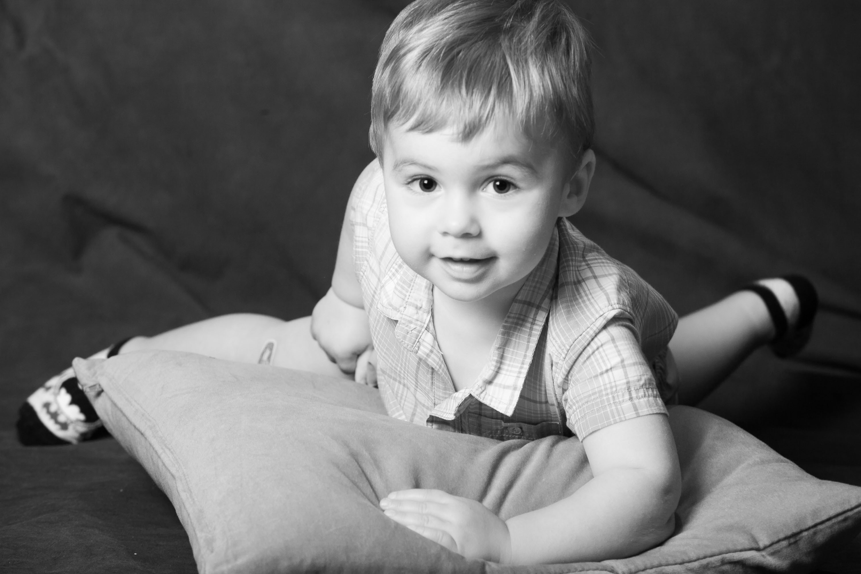 A portrait of a little boy with Batman socks, made in the Checkerbox studio.