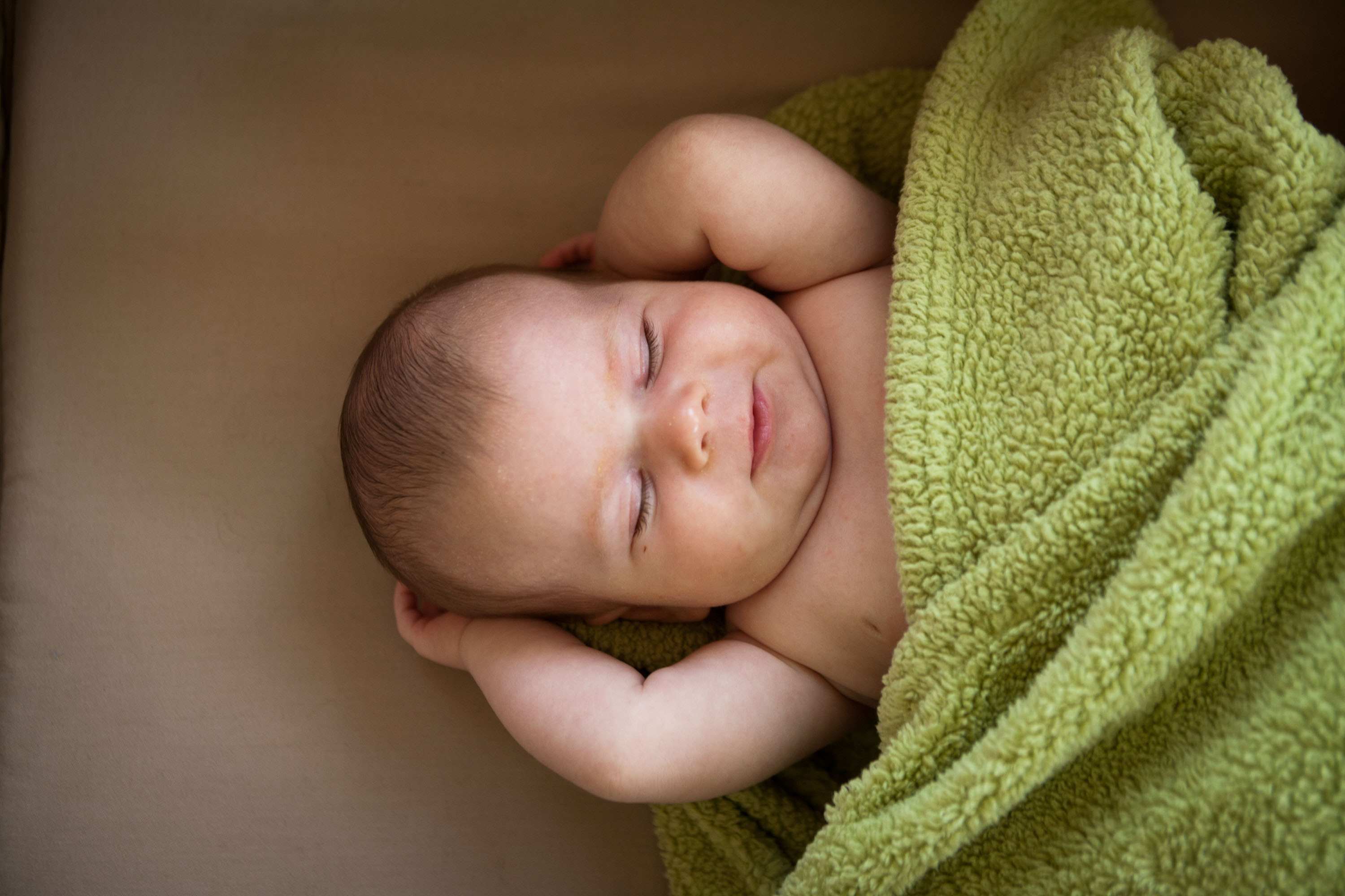 Hilarious portrait of a sleeping baby chilling in her crib.