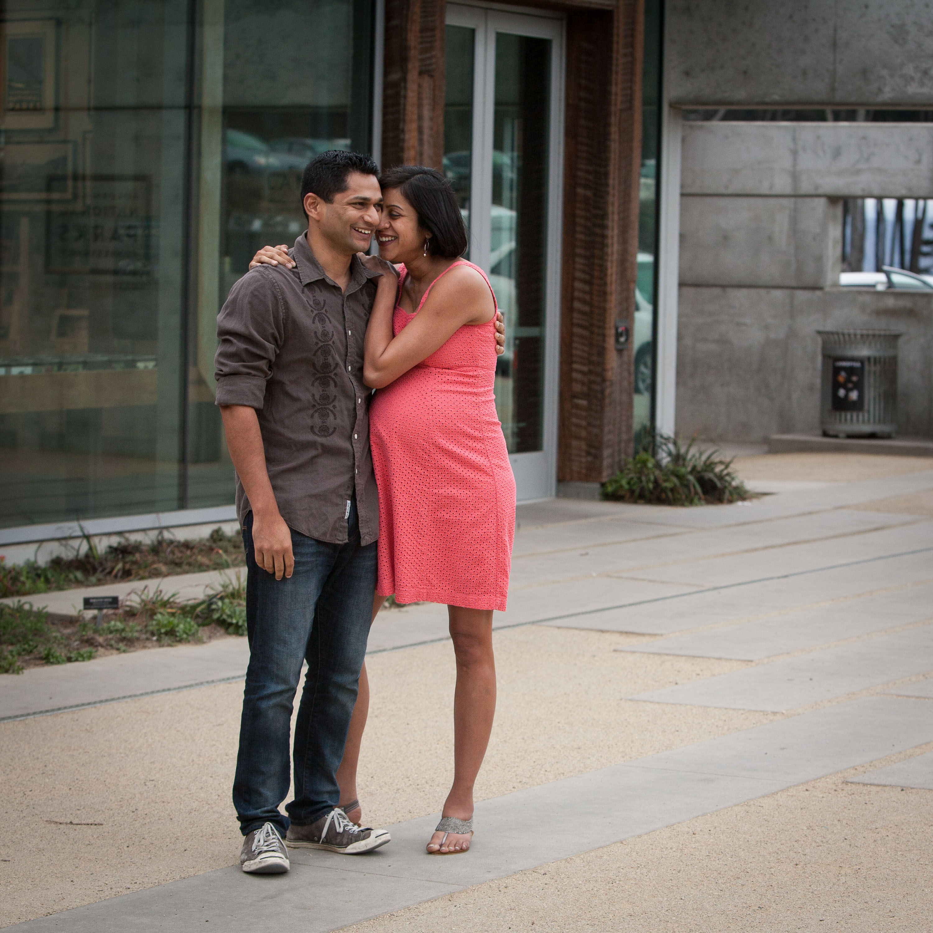 Soon-to-be parents laugh together is a modern maternity portrait at Lands End.