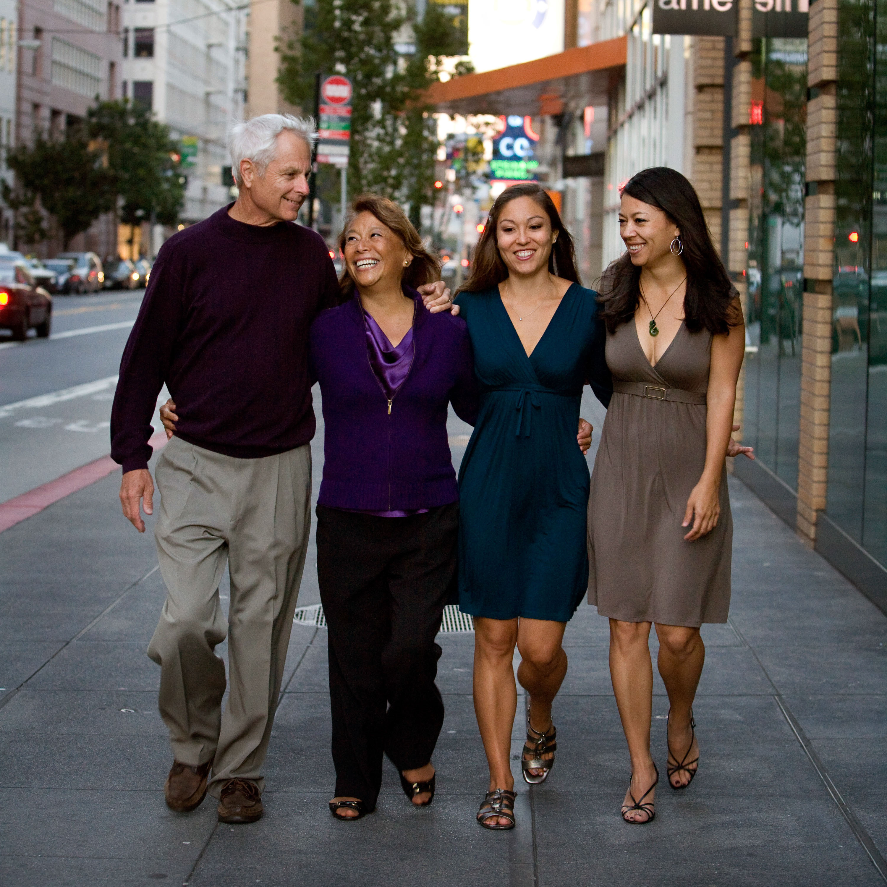 A dad and mom with their grown daugthers in a modern family portrait made in San Francisco.