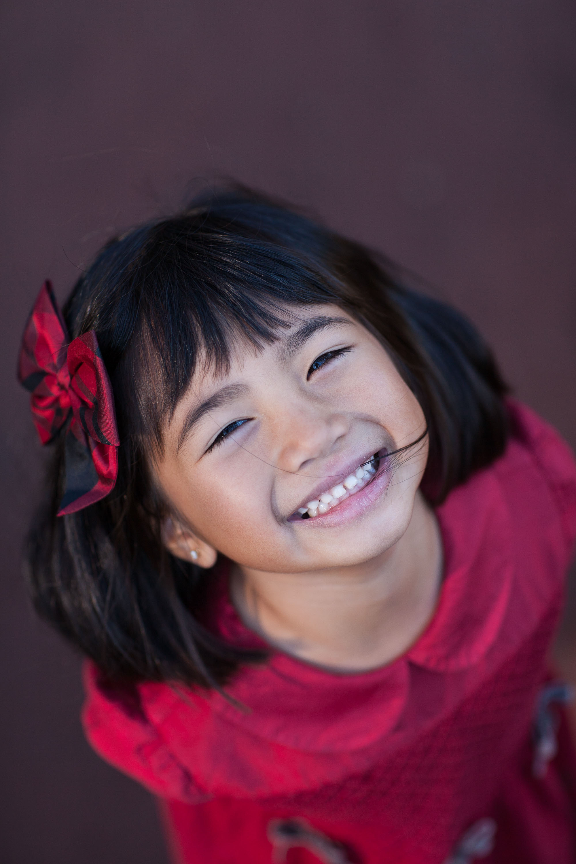 A playful Asian girl photographed from above at Glen Canyon Park by Checkerbox Photography.