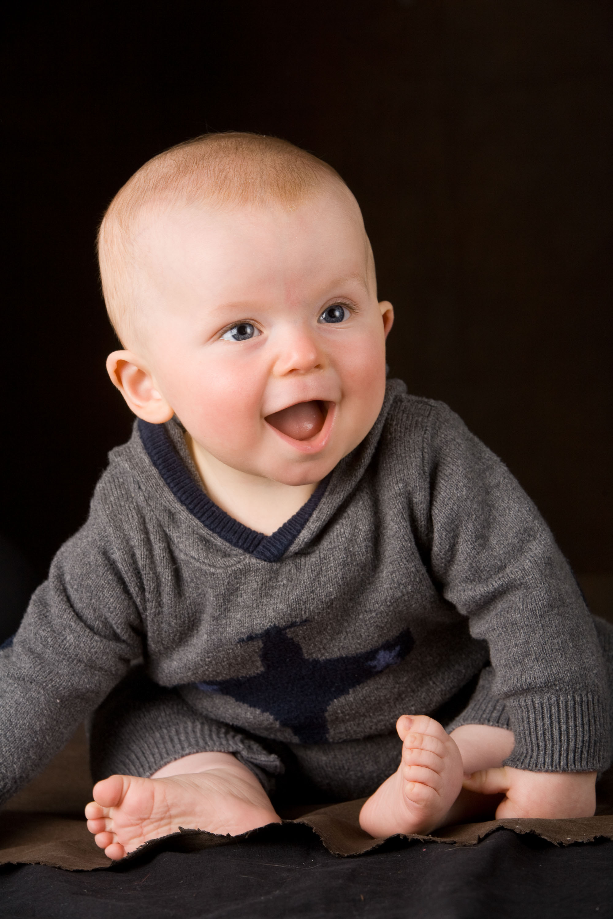 A beautiful baby boy in a sparkling studio portrait by Checkerbox Photography.