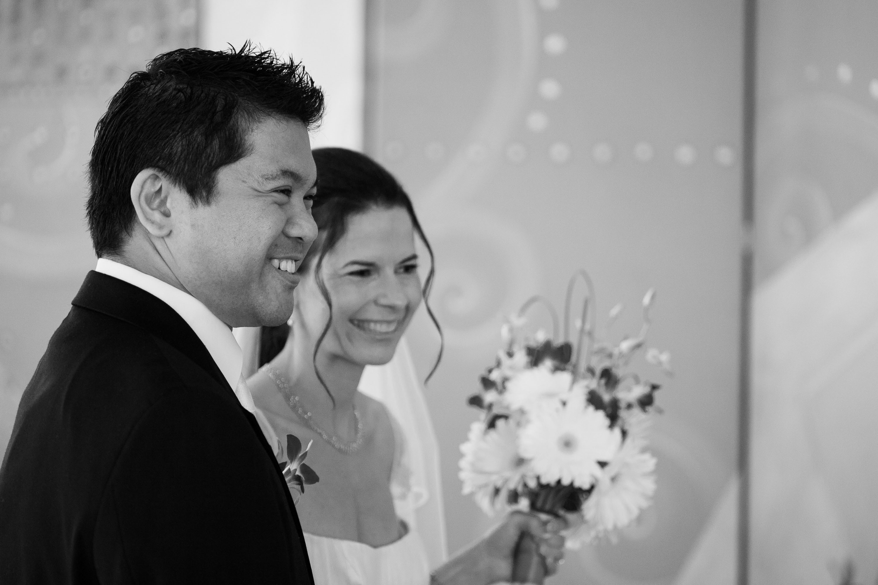 The bride and groom grin as they prepare for their wedding,  at the St. Francis Hotel in San Francisco