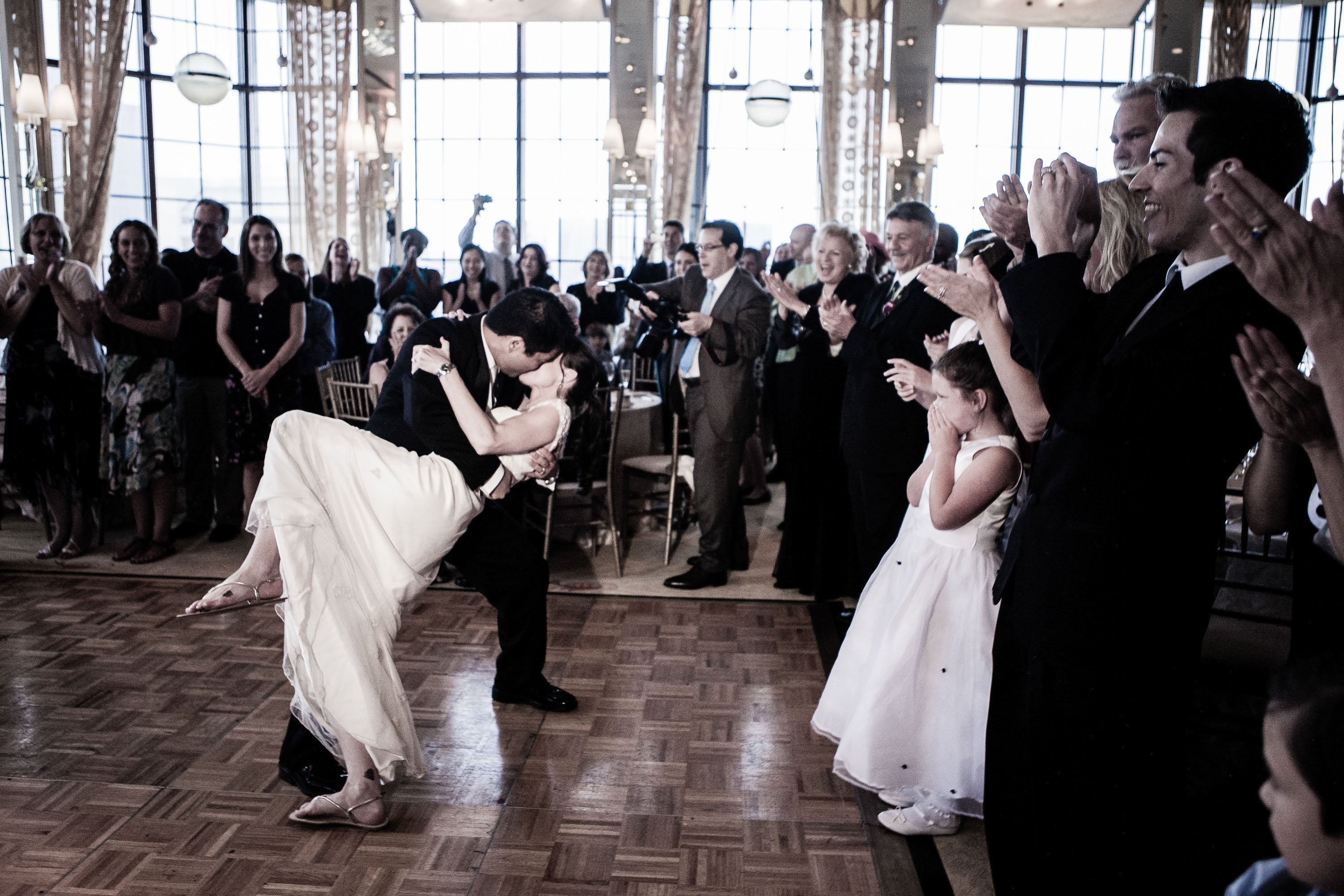 The groom dips the bride in a storybook ending to a perfect first dance,  at the St. Francis Hotel in San Francisco