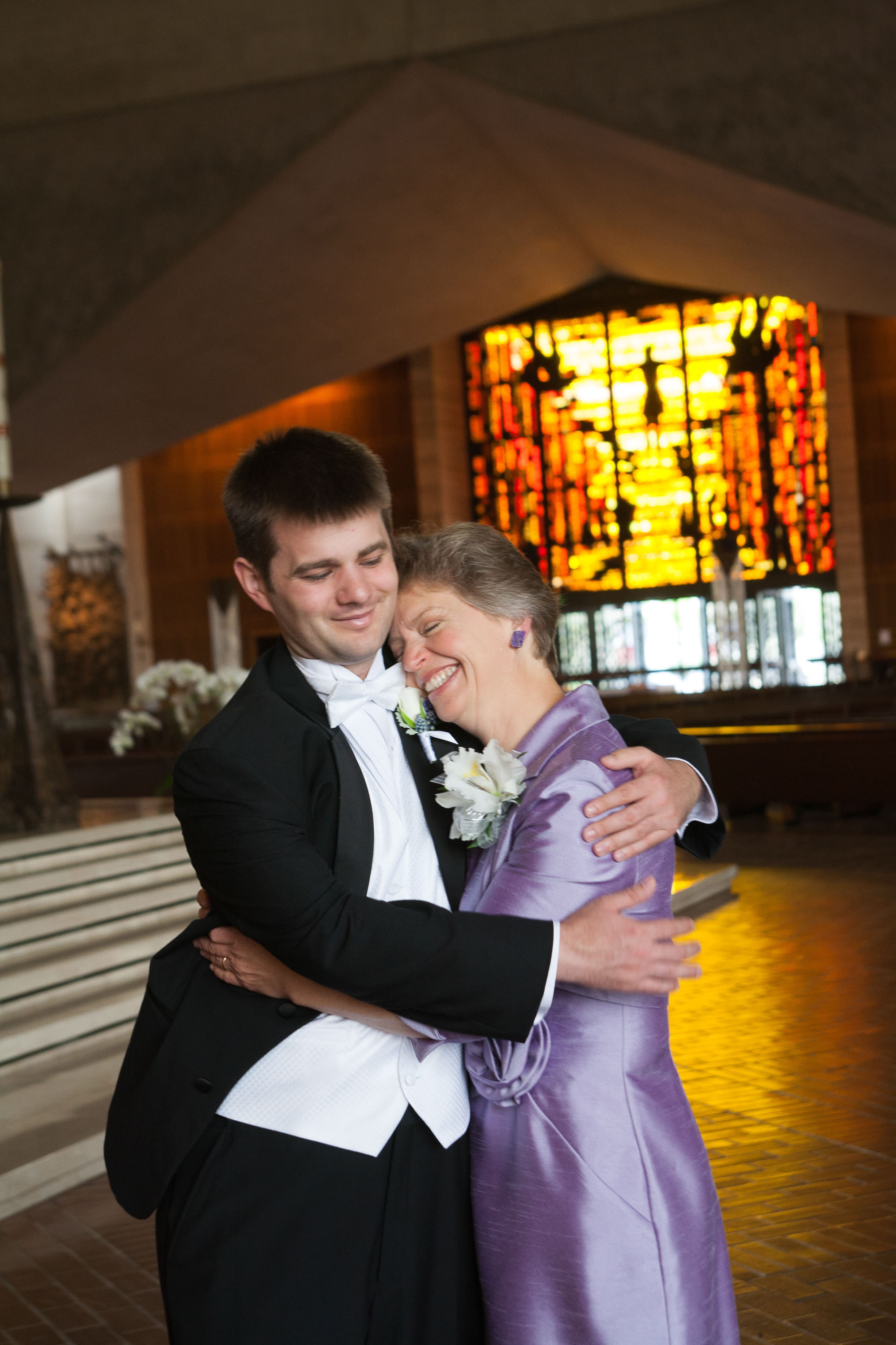 The groom hugs his very happy mom at St. Mary's Cathedral in San Francisco.