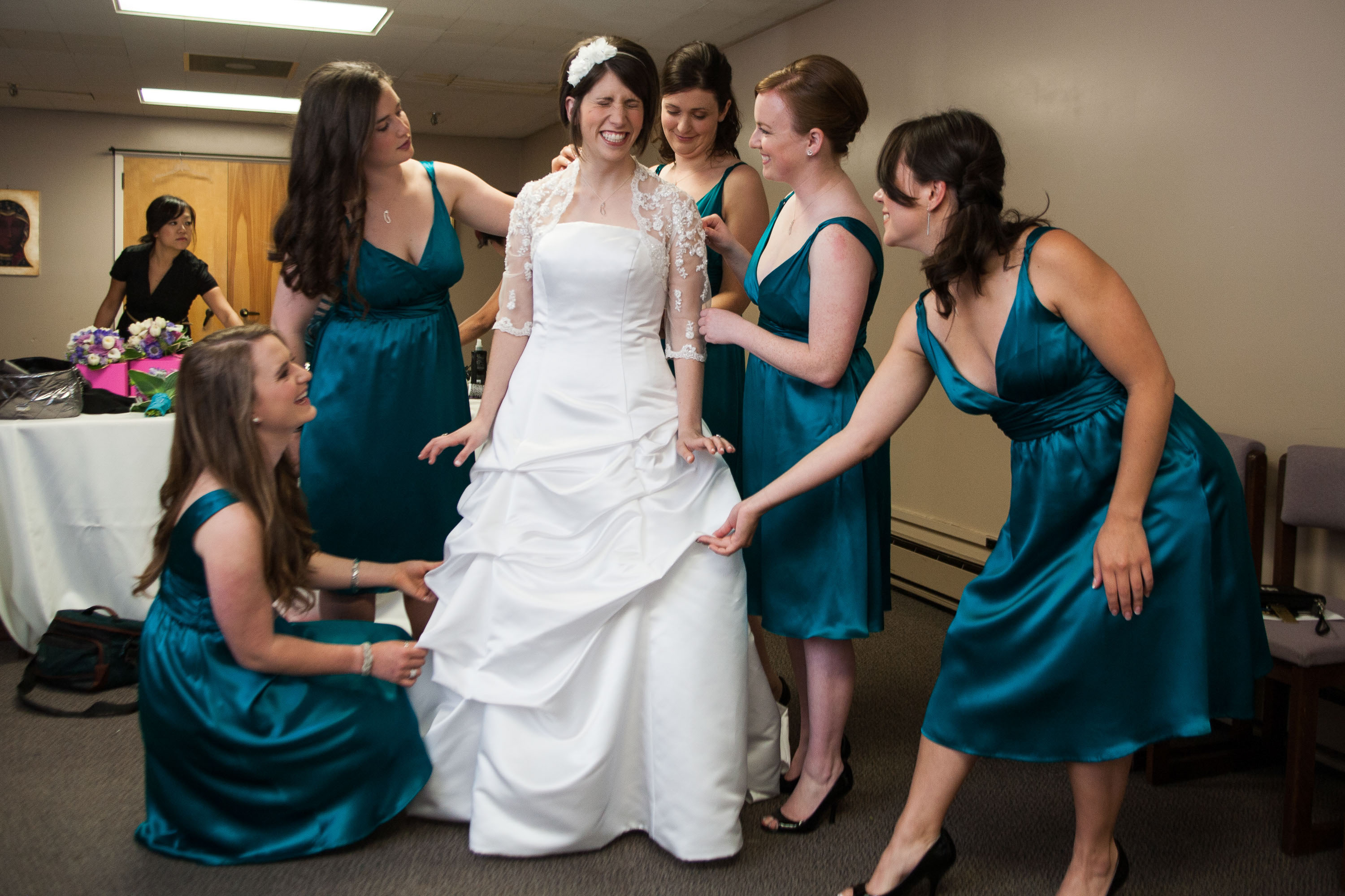 Bridesmaids make sure everything is perfect,  at St. Mary's Cathedral in San Francisco.